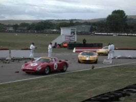 ford + 2 ferraris pick through wreckage.jpg